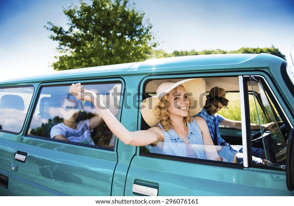 Teenage friends\
on a road trip on a summers day\
