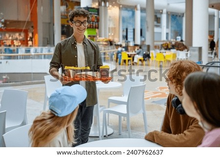 Teenage friends taking break during fun time at shopping mall