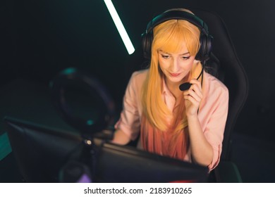 Teenage Gamer Girl Wearing Pigtails And Headset Communicating With Teammates Playing An Online Game. Gaming Computer Setup. . High Quality Photo