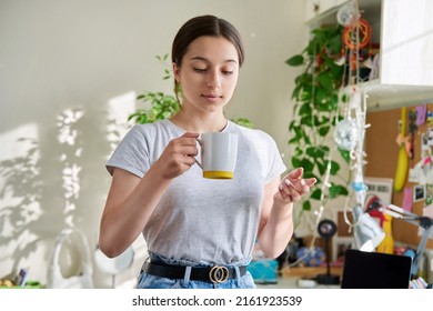 Teenage Girl 14, 15 Years Old Holding Mug, Standing At Home