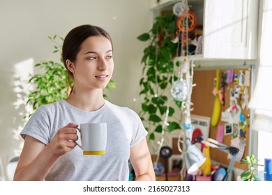 Teenage Girl 14, 15 Years Old Holding Mug, Standing At Home