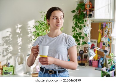 Teenage Girl 14, 15 Years Old Holding Mug, Standing At Home