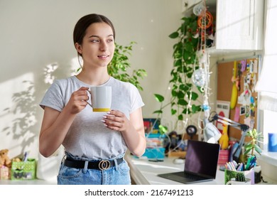 Teenage Girl 14, 15 Years Old Holding Mug, Standing At Home