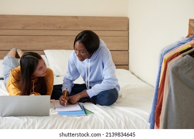 Teenage Girl Asking Friend To Help With Doing Homework For School