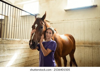 Teenage Girl Cares for a Brown Horse in Stall in Barn - Powered by Shutterstock