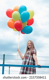 Teenage Girl With Colorful Helium Air Balloons Having Fun Outdoors. Tween Party. Enjoying Summer.