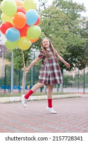 Teenage Girl With Colorful Helium Air Balloons Having Fun Outdoors. Tween Party. Enjoying Summer.