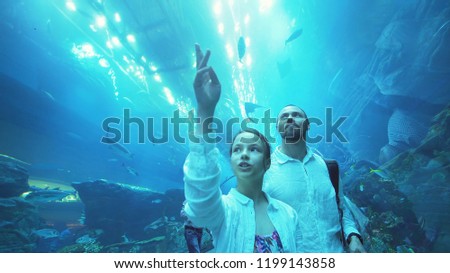 Teenage girl with Dad amusingly watching the fish in the Aquarium Stock photo © 