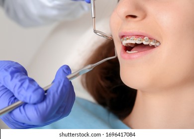 Teenage girl with dental braces visiting orthodontist in clinic - Shutterstock ID 1696417084