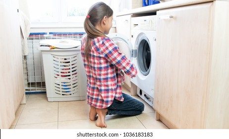 Teenage Girl Doing Housework In Laundry Room