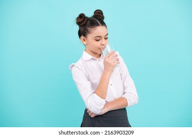 Teenage Girl Drinking Water From Glass Isolated On Blue Background. Daily Life Health. Happy Teenager, Positive And Smiling Emotions Of Teen Girl.