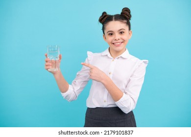 Teenage Girl Drinking Water From Glass Isolated On Blue Background. Daily Life Health. Happy Teenager, Positive And Smiling Emotions Of Teen Girl.