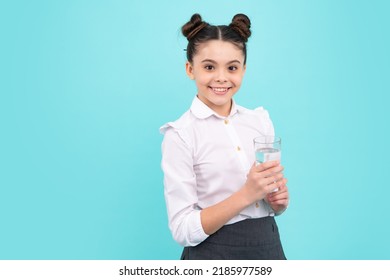 Teenage Girl Drinking Water From Glass On Isolated Blue Background. Daily Life Health. Happy Teenager, Positive And Smiling Emotions Of Teen Girl.