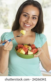 Teenage Girl Eating Fresh Fruit Salad