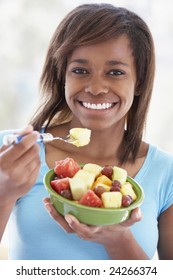 Teenage Girl Eating Fresh Fruit Salad