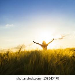Teenage girl enjoy with sunshine in wheat field