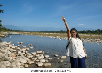 a teenage girl enjoying the view of Murti river valley - Powered by Shutterstock