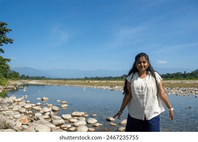 a teenage girl enjoying the view of Murti river valley - Powered by Shutterstock