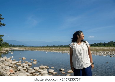 a teenage girl enjoying the view of Murti river valley - Powered by Shutterstock