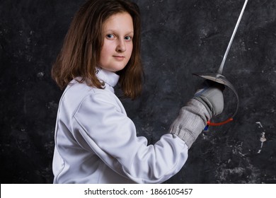 Teenage Girl Fencer Dressed In Uniform With Epee And Helmet