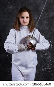 Teenage Girl Fencer Dressed In Uniform With Epee And Helmet