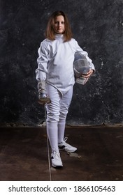 Teenage Girl Fencer Dressed In Uniform With Epee And Helmet