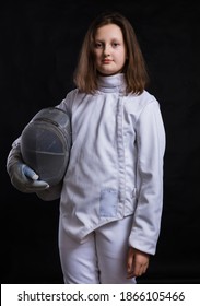 Teenage Girl Fencer Dressed In Uniform With Epee And Helmet