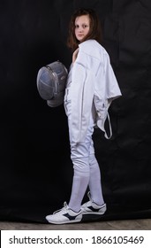 Teenage Girl Fencer Dressed In Uniform With Epee And Helmet