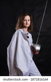 Teenage Girl Fencer Dressed In Uniform With Epee And Helmet