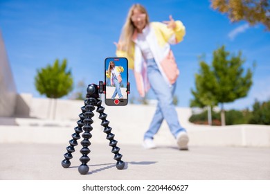 Teenage girl filming video of herself on mobile phone - Shutterstock ID 2204460627