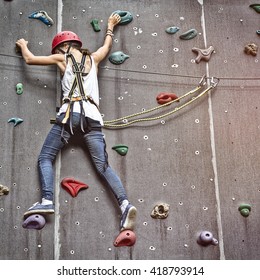 teenage girl in a free climbing wall