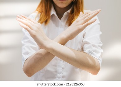 teenage girl generation Z with her arms crossed at her chest demonstrates Break The Bias symbol of international women's day principles of feminism, gender equality and support