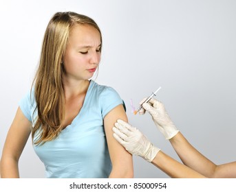 Teenage Girl Getting Flu Shot Needle Vaccination In Arm