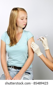 Teenage Girl Getting Flu Shot Needle Vaccination In Arm