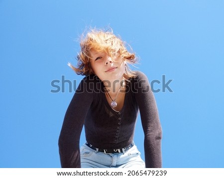 Similar – Young blonde woman in a sunny day in the city