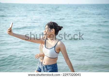 Teenage girl having fun on sea beach,Summer vacation,Sunny hot summer day at tropical ocean beach.