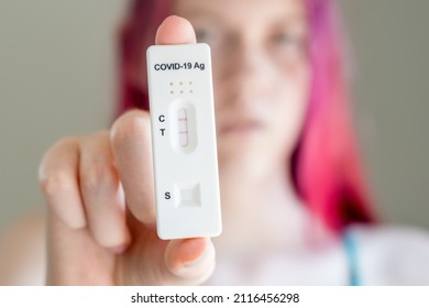 Teenage Girl Holding Covid-19 Rapid Antigen Test Cassette With Positive Result Of Rapid Diagnostic Test. Selective Focus