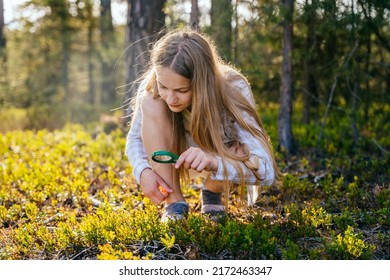 Teenage girl holding magnifying glass explores nature and the environment. Future profession ecologist or biologist. - Powered by Shutterstock