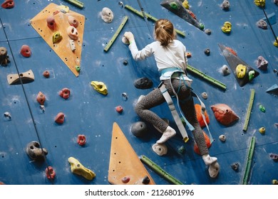 Teenage Girl At Indoor Climbing Wall. Kid Having Fun At Bouldering Wall. Child Learning At Climbing Class. Sports Healthy Lifestyle. Youth At Climbing Summer Camp