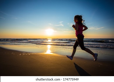 Teenage girl jumping, running on beach  - Powered by Shutterstock