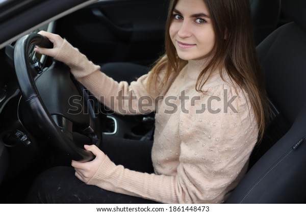 Teenage girl learning to drive\
car