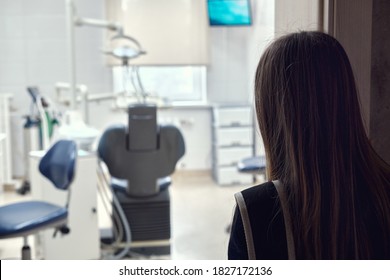 Teenage girl looking at the dentist's office - Shutterstock ID 1827172136
