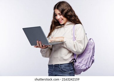 Teenage Girl Looking At Her Laptop, Getting Ready For School And Finishing Homework