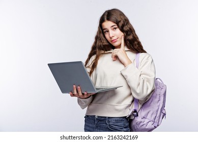 Teenage Girl Looking At Her Laptop, Getting Ready For School And Finishing Homework