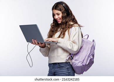 Teenage Girl Looking At Her Laptop, Getting Ready For School And Finishing Homework