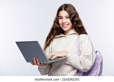 Teenage Girl Looking At Her Laptop, Getting Ready For School And Finishing Homework