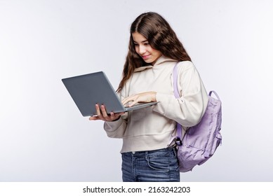 Teenage Girl Looking At Her Laptop, Getting Ready For School And Finishing Homework