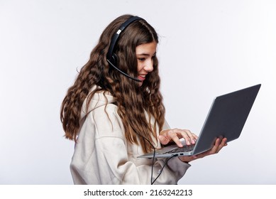 Teenage Girl Looking At Her Laptop, Getting Ready For School And Finishing Homework