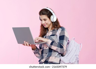 Teenage Girl Looking At Her Laptop, Getting Ready For School And Finishing Homework