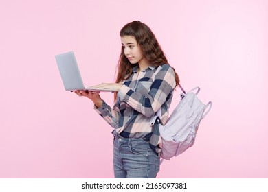 Teenage Girl Looking At Her Laptop, Getting Ready For School And Finishing Homework